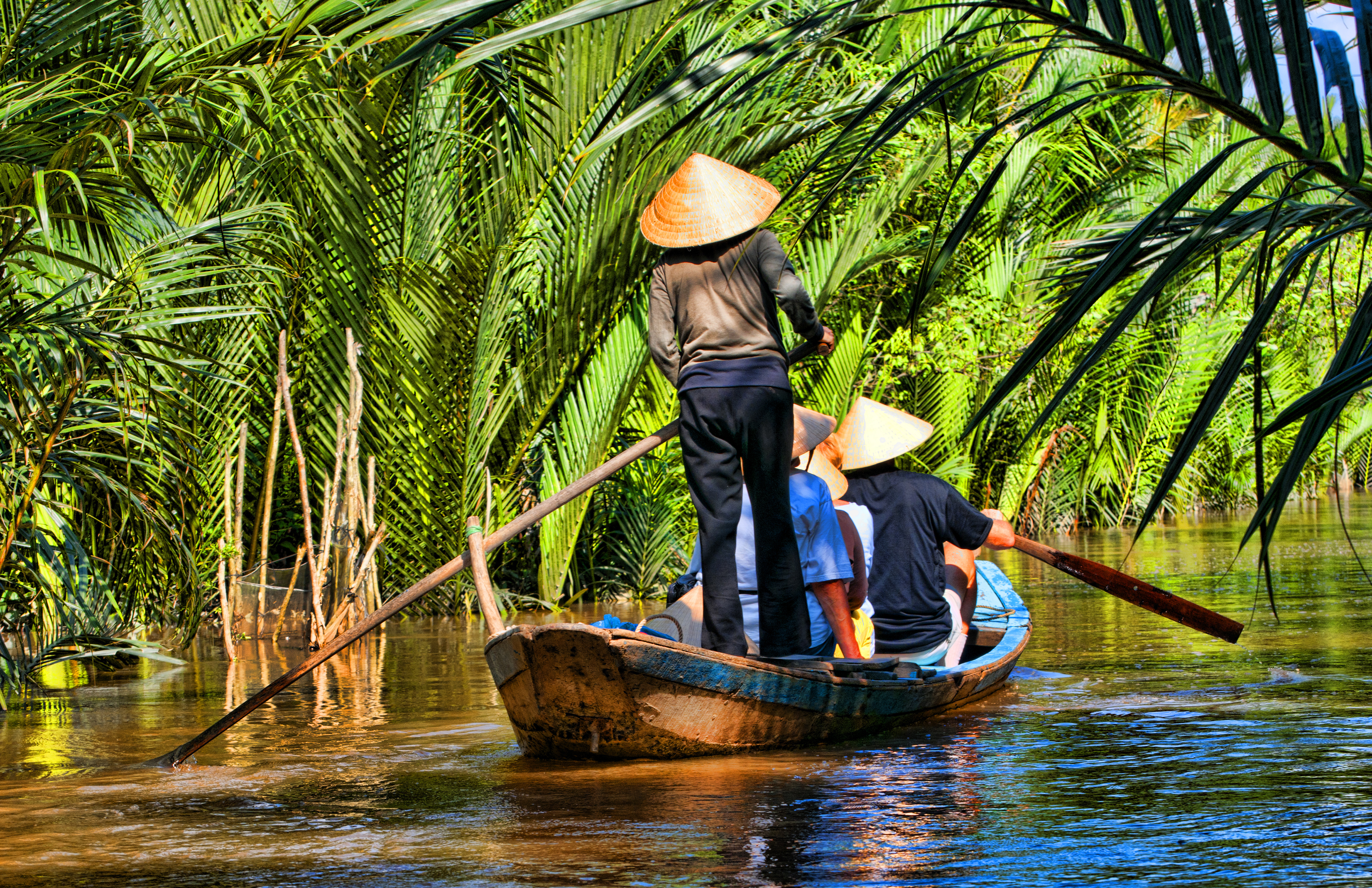 a small boat cruises through the waterways of Vietnam.